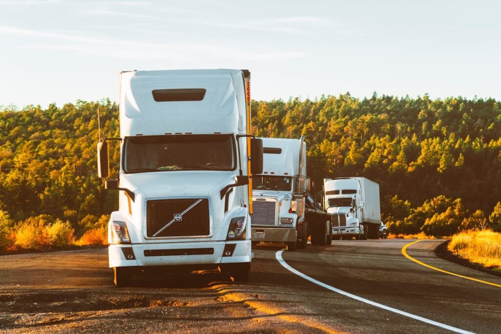 pexels-photo-2199293 Three semi trucks driving on a highway through a forested landscape in Arizona.